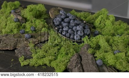 Freshly Picked Blueberries In Wooden Bowl. Juicy And Fresh Blueberries With Green Leaves On Rustic T