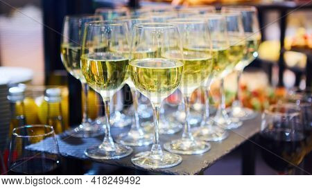 Glasses Of White Wine Are On The Table, Ready To Serve