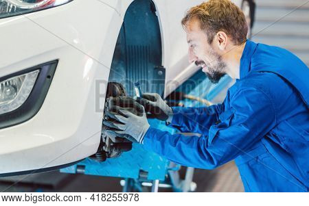 Auto mechanic servicing car in the workshop