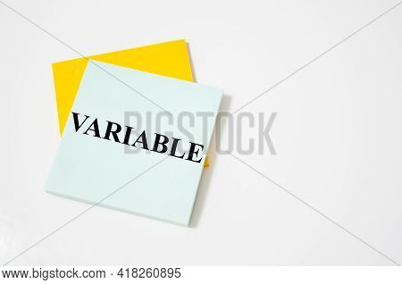 The Variable Written On A White Notepad With Colored Pencils And A Yellow Background