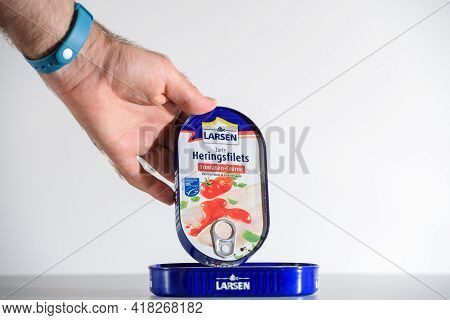 Paris, France - Jul 30, 2017: Male Hand Showing Presenting The Package Of Larsen Zarte Heringsfilet 