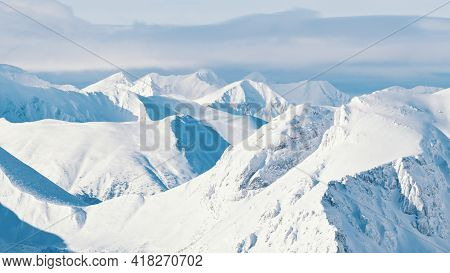 Snow-capped Mountain Peak With Cloudy Blue Sky In The Background - Winter Mountains. High Quality Ph