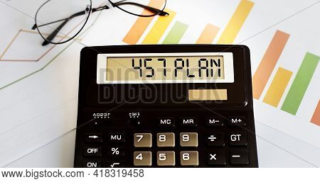 Calculator With The Word 457 Plan On The Display With Chart And Glasses