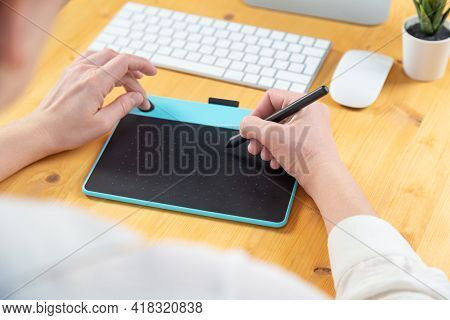 Hand Of Graphic Designer Working With Stilus And Tablet