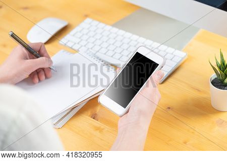 Woman Hands Close Up Working On White Computer Keyboard And Smartphone, Work From Home Concept. Work
