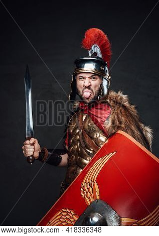 Funny Roman Soldier Taunts His Enemy Against Dark Background