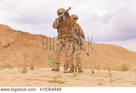 Equipped And Armed Special Forces Soldiershooting On The Battlefield. Concept Of Military Anti-terro
