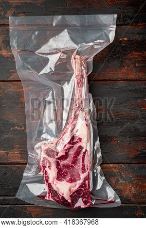 Tender Raw Trimmed Bone-in Ribeye Tomahawk Steak In Pack Set, On Old Dark  Wooden Table Background, 
