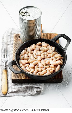 White Canned Beans Set, With Metal Can, In Cast Iron Frying Pan, On White Stone  Surface