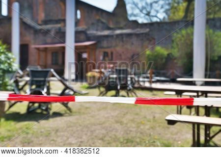 Barrier Tape Blocking Off Closed Beer Garden Restaurant During Corona Virus Lockdown
