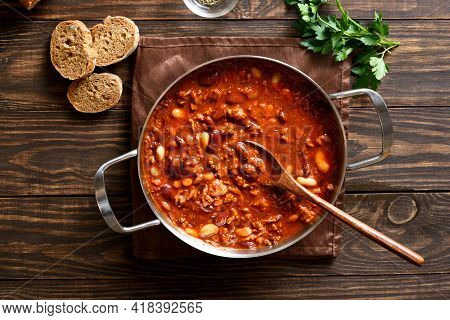 Cowboy Beans With Ground Beef, Jalapeno Pepper And Bacon In Cooking Pan Over Wooden Background. Top 