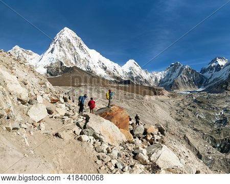 Mount Kala Patthar And Mount Pumo Ri With Tourists Near Gorak Shep Village On The Way To Everest Bas