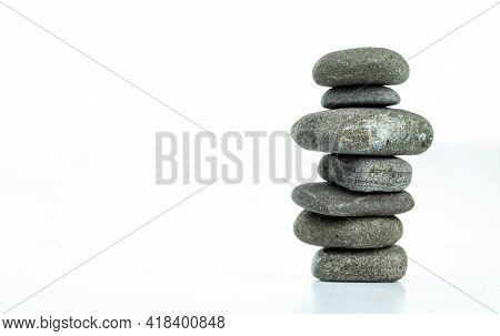 Pebble Pyramid In Balance Are Isolated On A White Background. Stones Pyramid Symbolizing Zen, Harmon