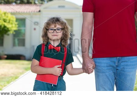 Father Walking Son To School. Parent And Pupil Of Primary School Schoolboy With Backpack.