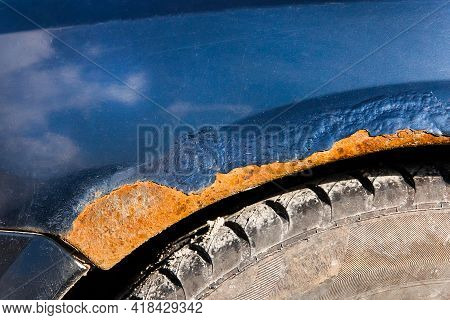 Traces Of Rust And Tear Close-up On The Old Dirty Metal Surface Of The Car. Amortization Of The Mach