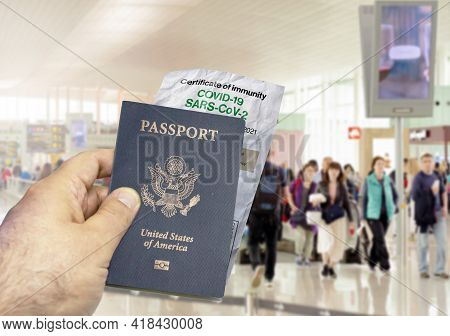 Hand Holding A Us Passport With A Wrinkled Paper Coronavirus Covid 19 Immunity Certificate Blurred A