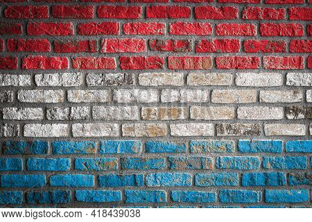 National Flag Of Luxembourg Depicting In Paint Colors On An Old Brick Wall. Flag  Banner On Brick Wa