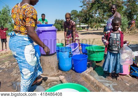 Mzuzu, Malawi. 30-05-2018. Mother And Children From The Community Are Gathered To Fetch Drinkable Wa