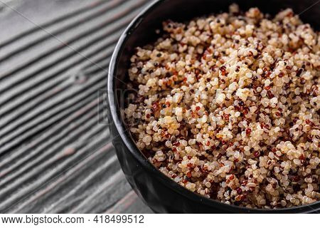 Bowl Of Healthy Quinoa On A Dark Wooden Rustic Background