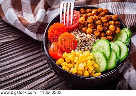 Bowl Of Healthy Quinoa With Vegetables On A Dark Rustic Background