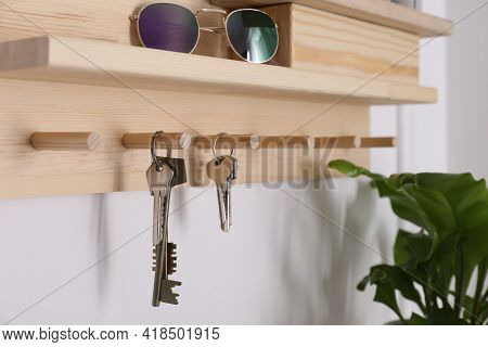 Wooden Hanger For Keys On White Wall, Closeup
