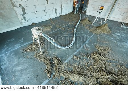 Unknown Builders Working Using Pneumatic Conveyor And Tacheometer In A Flat Of Building Under Constr