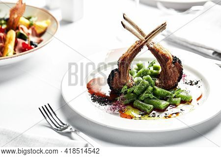 Steak On The Bone. Tomahawk Steak On A White Background. Top View. Free Copy Space.