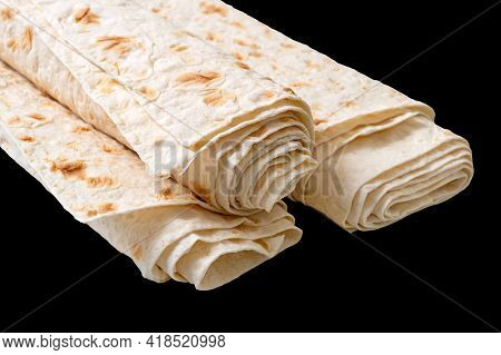Rolled Up Thin Pita Bread Isolated On Black Background. Lavash - Tasty Hearty Healthy Armenian And T