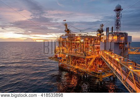 Offshore Oil And Gas Central Processing Platform In Sun Set Which Produce Raw Gas, Crude And Hydroca