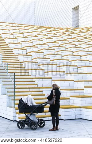 Billund, Denmark - October 30, 2017: The Lego House Building In Billund And A Woman With A Stroller.