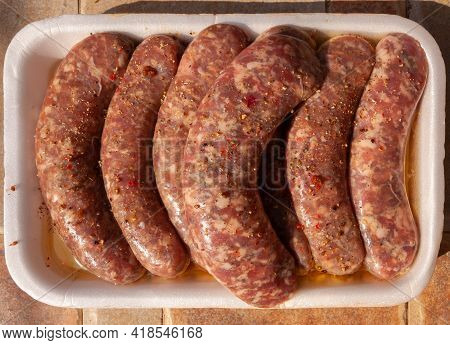 Fresh Sousages On An Outdoor Table Ready To Be Cooked.