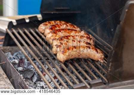 Delicious Grilled Sousages. Barbiquing Sousages On Hot Grill.