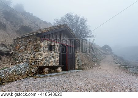 Mountain Refuge On A Cold Day With Intense Fog And Mysterious Atmosphere. Morcuera Madrid.