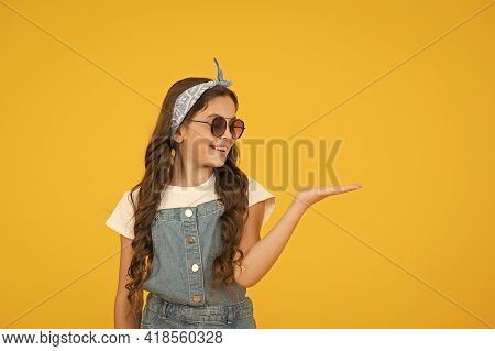 Retro Girl Presenting Product. Small Kid Wear Summer Outfit. Cheerful Child Has Vintage Look. Headke