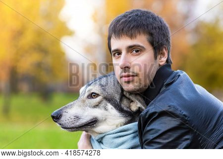 Young Happy Man Hugging Dog. Pet Adoption.  Czechoslovak With Male Owner. Boy Walking, Playing, Trai