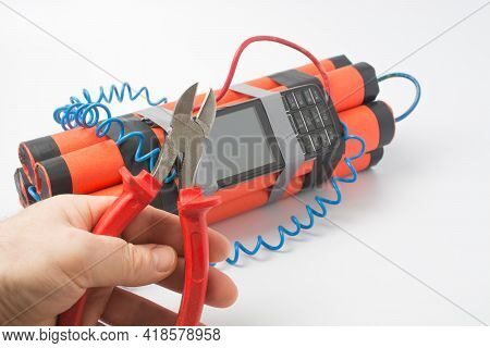A Man With Side Cutters Wants To Cut The Red Wire On The Bomb So That An Explosion Does Not Occur. S