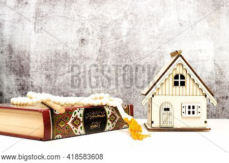 A Picture Of Holy Quran With Tasbeeh And House Miniature On Isolated Crack Wall Background For 