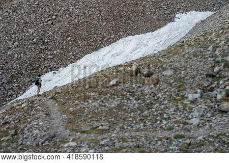 Woman Stands At The Bottom Of Rock Glacier In Graet Basin National Park