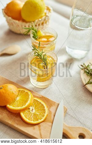 Citrus And Rosemary Fresh Lemonade In Glass On A White Table At Home