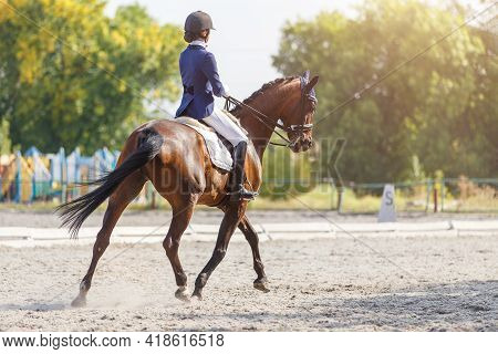 Young Girl Riding Horse At Dressage Advanced Test