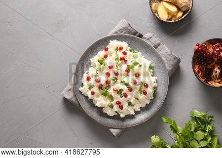Curd Rice With Cashews, Grapes, Cilantro On A Grey Background.
