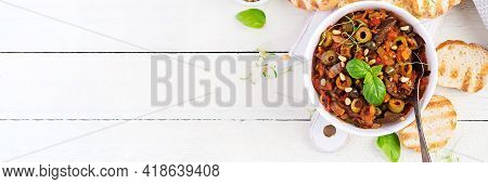 Traditional Italian Caponata And Toast On A Wooden White Table. Sicilian Caponata. Top View, Above, 