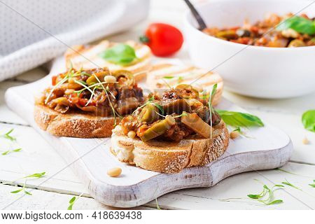 Traditional Italian Caponata And Toast On A Wooden White Table. Sicilian Caponata.