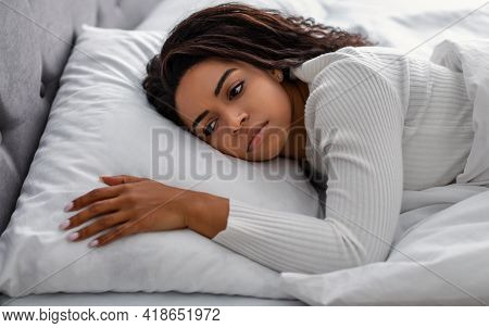 Depressed Black Woman Lying In Bed Alone And Feeeling Upset