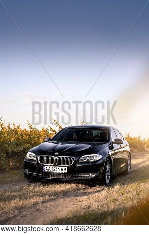 Kherson, Ukraine - June 2019. Black Bmw 5-series F10 In The Vineyards.