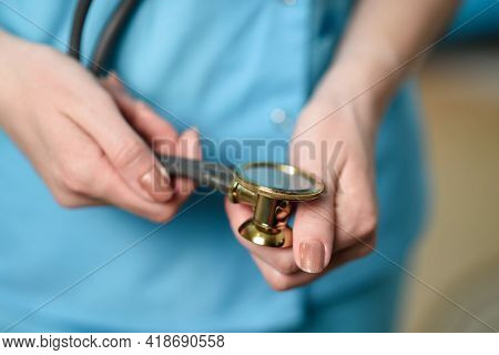 The Doctor Holds A Stethophonendoscope In His Hands. Close-up
