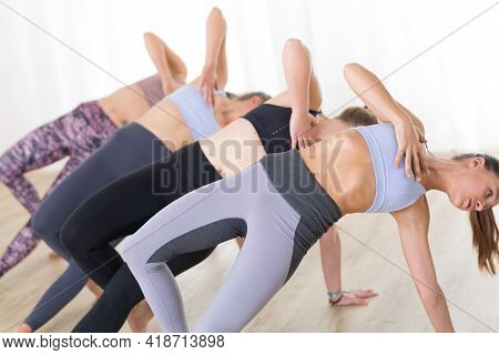 Group Of Young Sporty Attractive Women In Yoga Studio, Practicing Yoga Lesson With Instructor, Formi