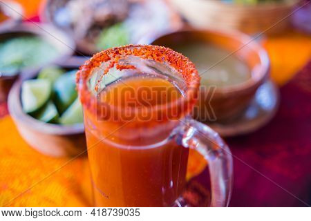 Traditional Mexican Michelada In Glass Mug With Blurry Background
