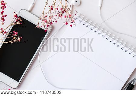 Open Blank Notebook With Headphones Mobile Phone. Black Screen And Black Pen. Copy Space Foe Text. T