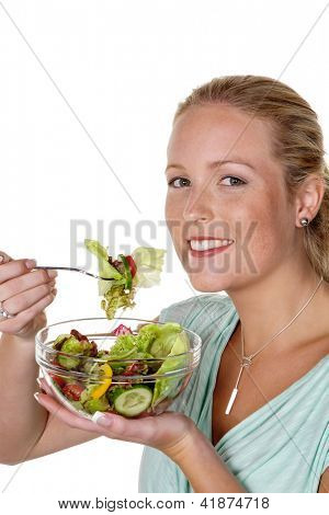 a young woman eating a fresh salad at lunch. healthy diet with vitamins.